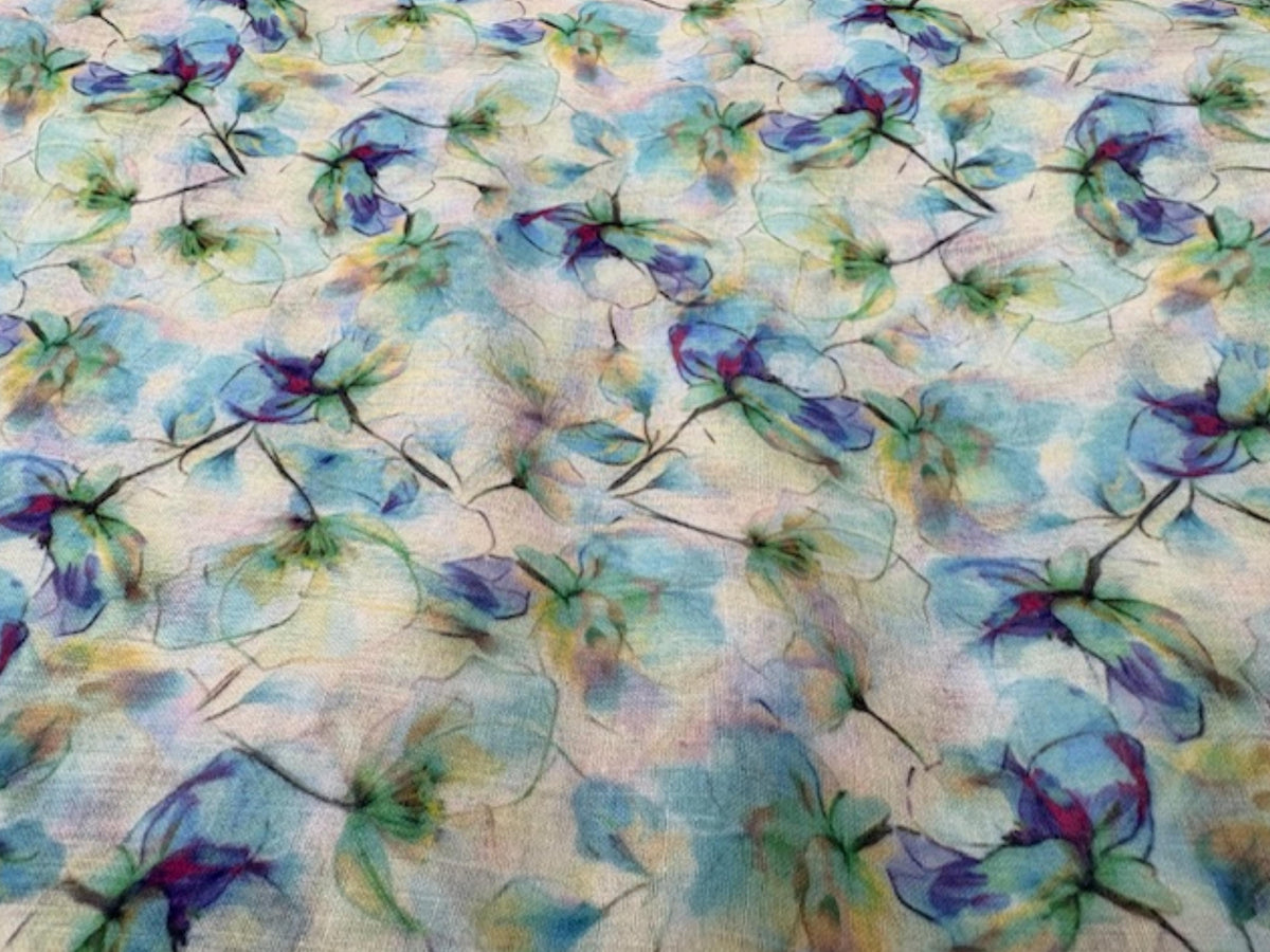 Printed voile fabric with aqua mist watercolour floral pattern, lightweight and sheer, ideal for clothing and home decor projects.