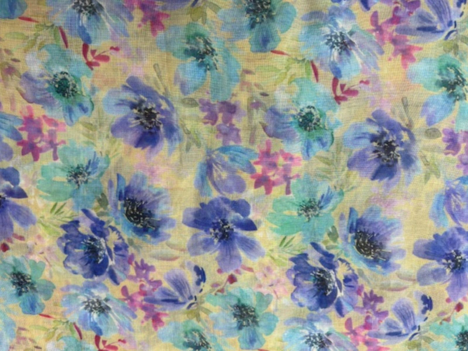 Purple printed voile fabric with watercolor floral design, lightweight and sheer material suitable for clothing and home décor.