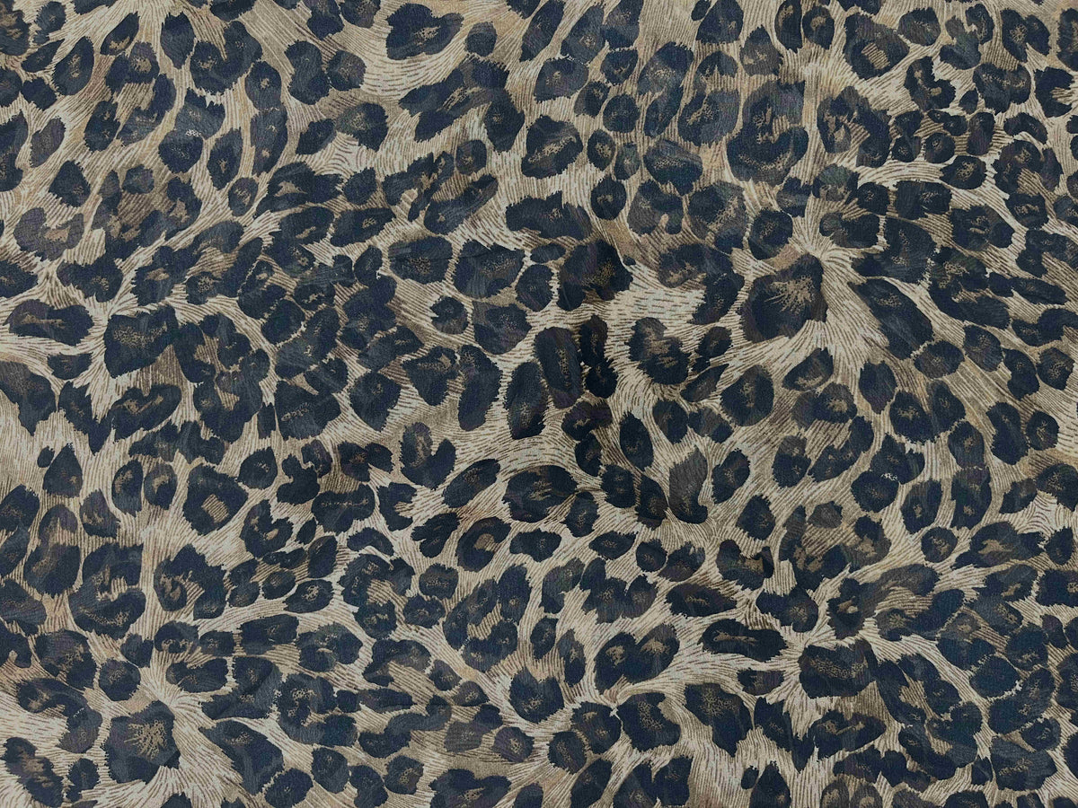 Beige printed chiffon fabric with animal pattern from Cheap Fabrics, showcasing soft, lightweight material ideal for fashion and craft projects.