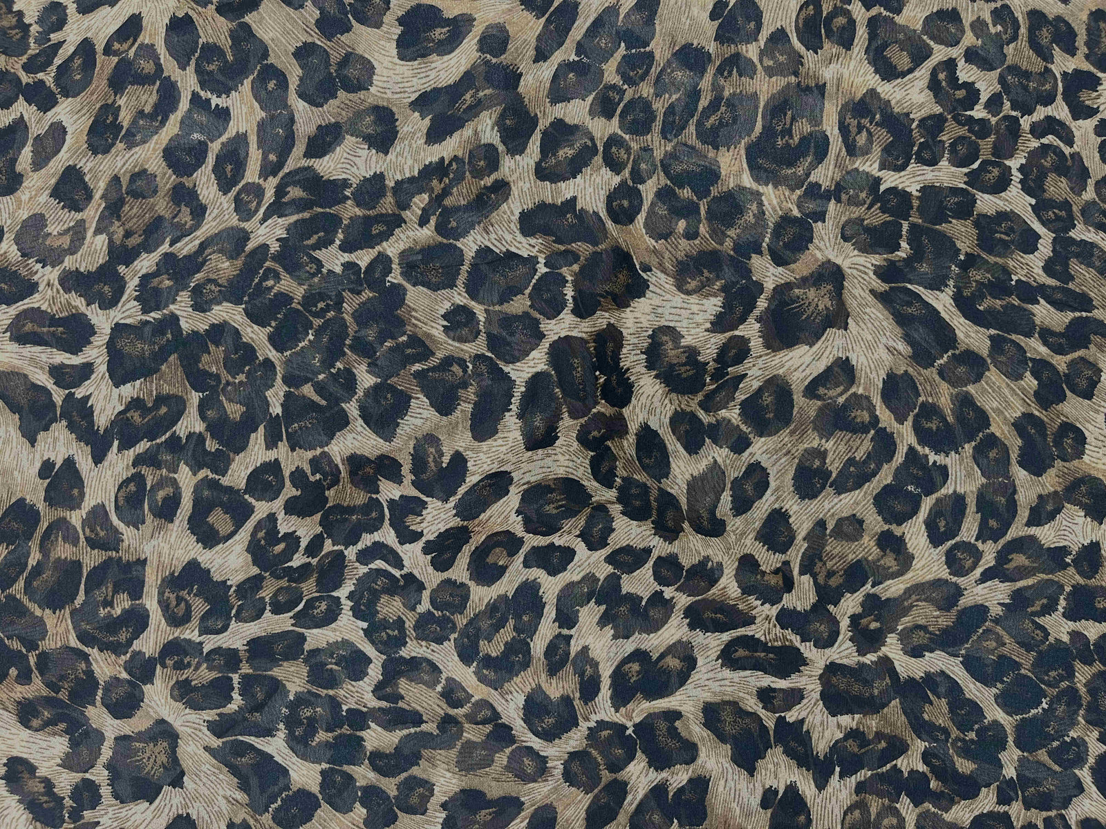 Brown printed chiffon fabric with animal print pattern, soft and lightweight textile from Cheap Fabrics.