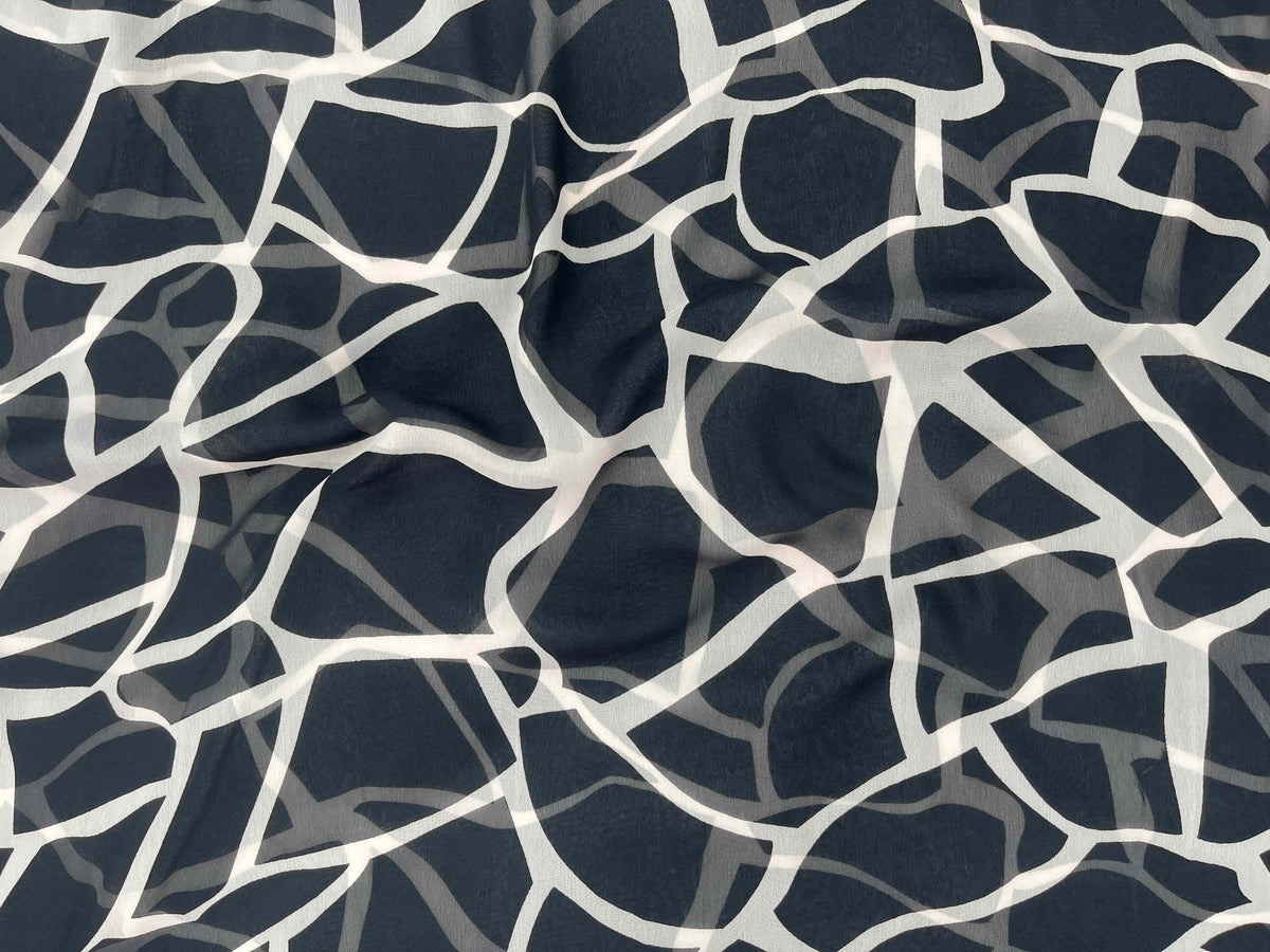 Printed chiffon fabric featuring a giraffe pattern from Cheap Fabrics' Monotone Collection, showcasing soft, lightweight textile design.