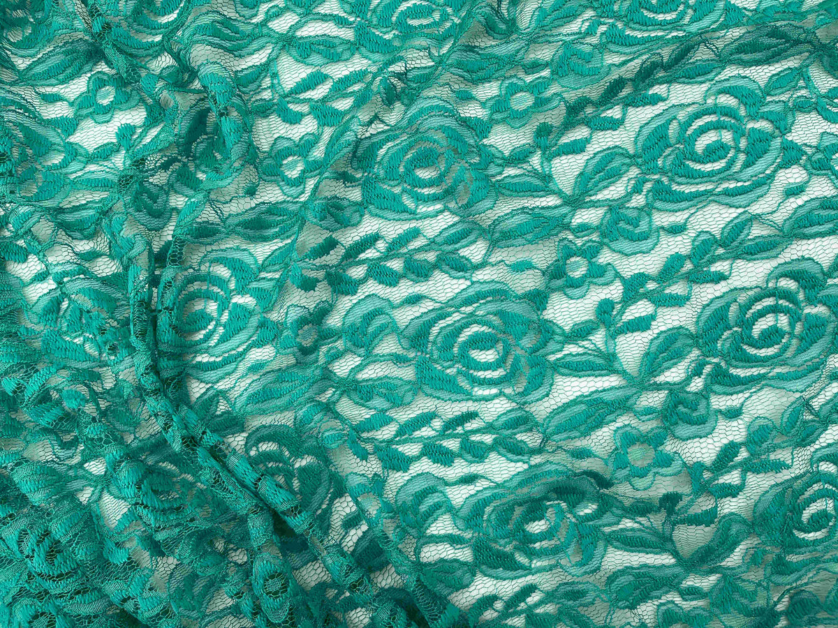 Rose lace fabric in soft jade color, featuring intricate floral lace pattern, ideal for elegant sewing and craft projects.