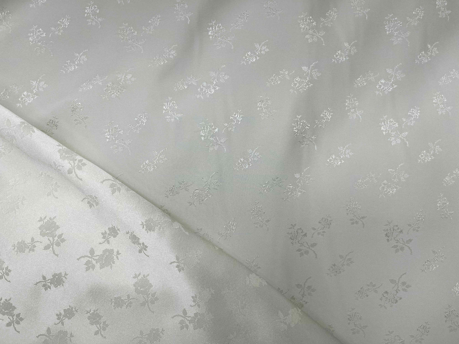 Cream satin-backed jacquard fabric featuring elegant English Rose pattern, by Cheapfabrics, suitable for upholstery or fashion projects.