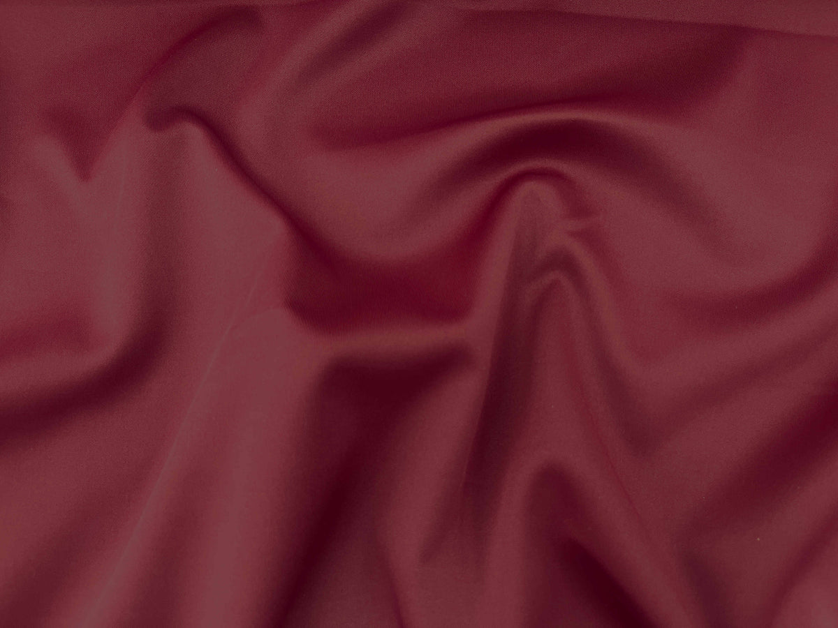 Maroon plain scuba fabric from Cheapfabrics, showcasing smooth, stretchy material ideal for fashion and craft projects.
