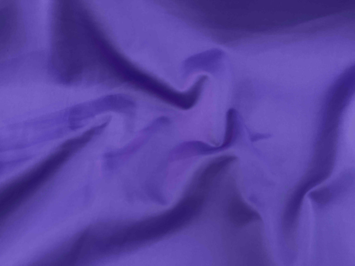 Purple plain scuba fabric from Cheapfabrics, showing a smooth, stretchy textile ideal for fashion and activewear projects.