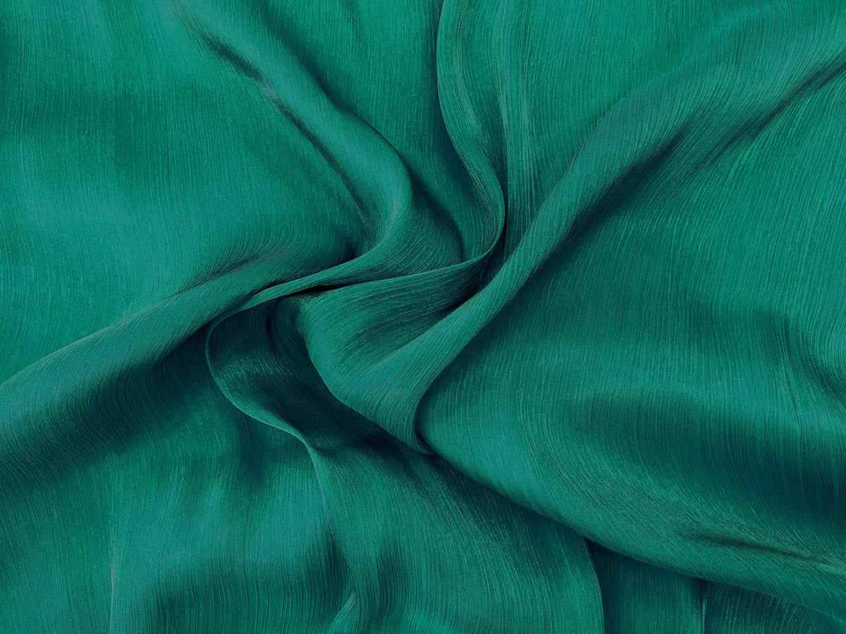 Forest green shimmer satin chiffon fabric by Cheap Fabrics, showcasing smooth, shiny, lightweight chiffon material with a shimmering finish.