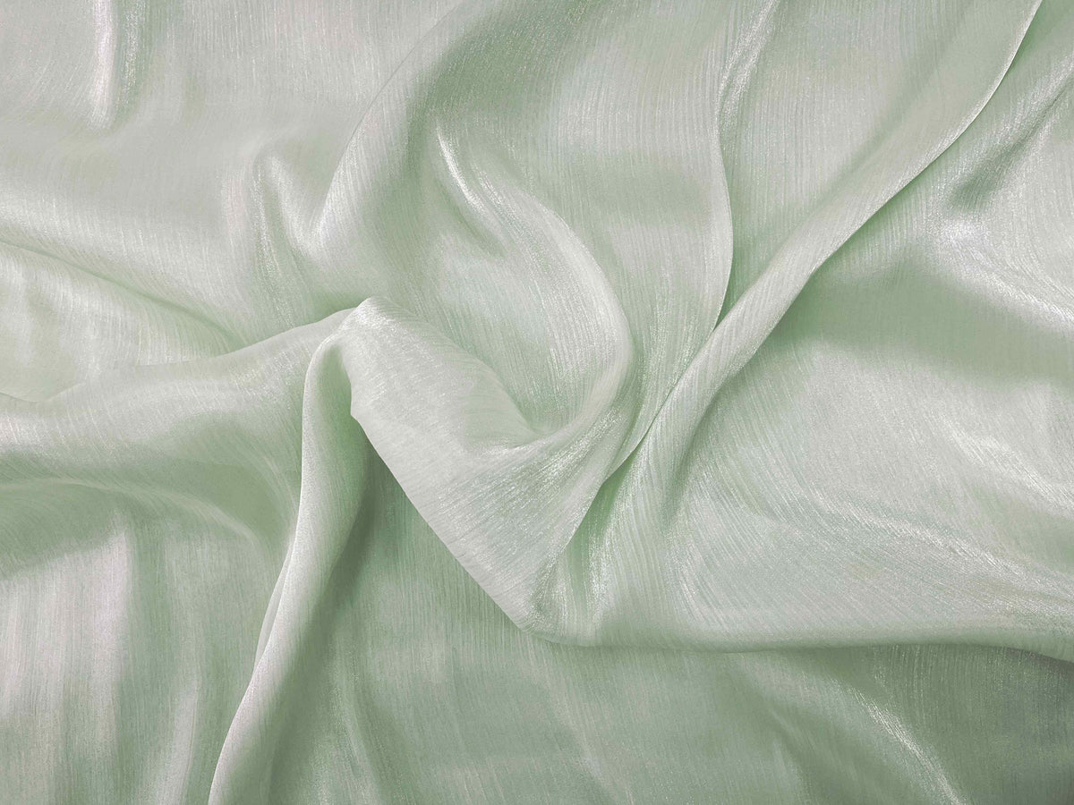Light green shimmer satin chiffon fabric from Cheap Fabrics, showcasing smooth, flowing, and shiny chiffon material.