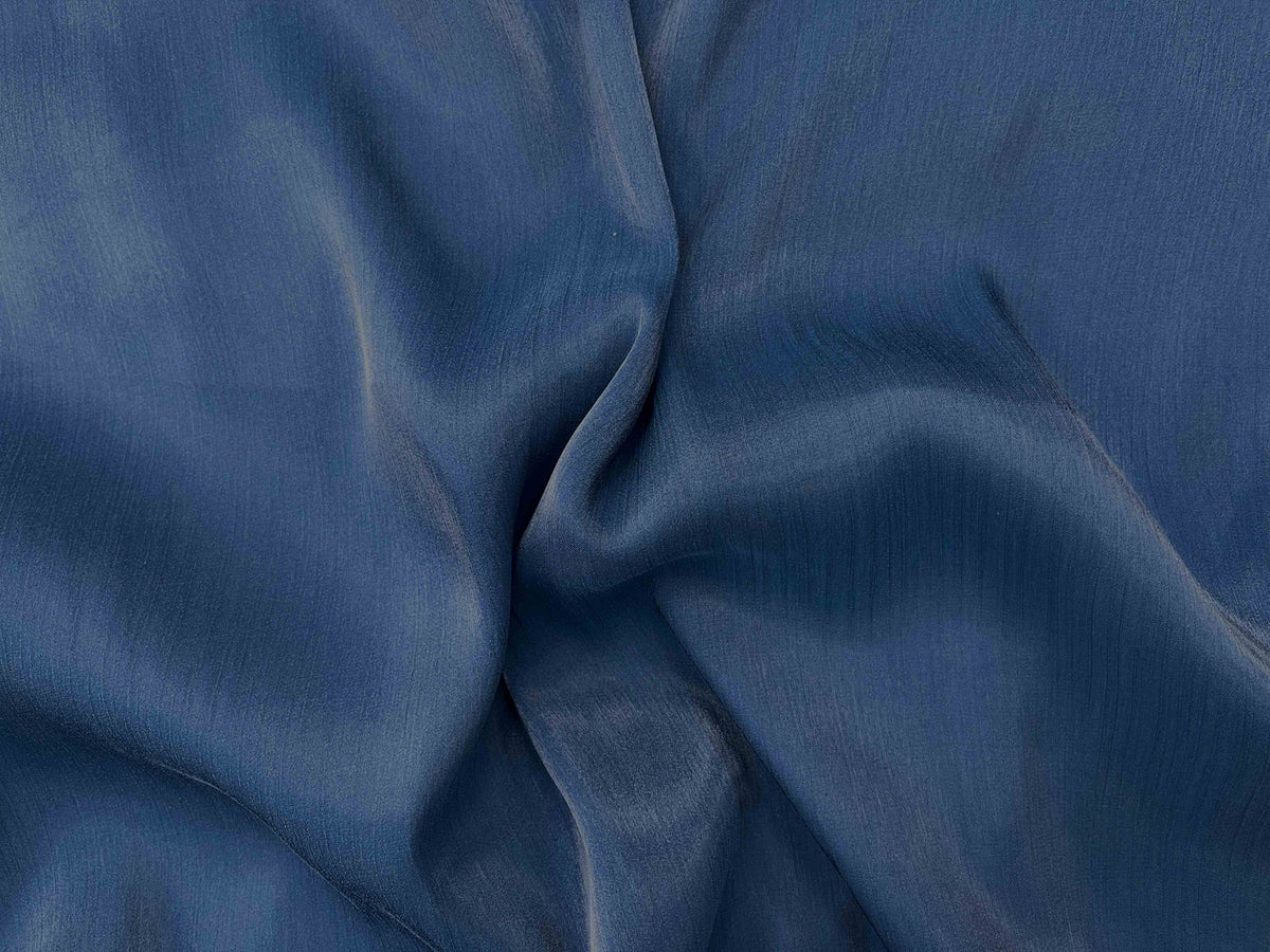 Marine blue shimmer satin chiffon fabric from Cheap Fabrics, showcasing its elegant, lightweight, and shiny material.