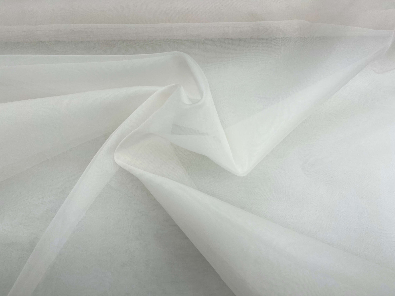 Ivory silk organza fabric by Cheap Fabrics, showing a smooth, sheer silk material with a delicate, lightweight texture.