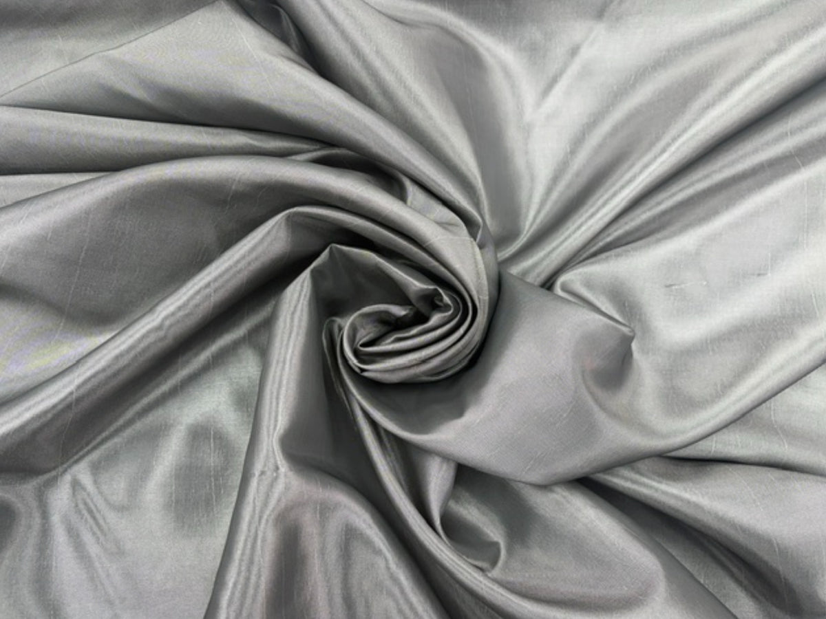 Silver taffeta fabric by Cheapfabrics, showcasing smooth, shiny, and luxurious taffeta material ideal for elegant garments.