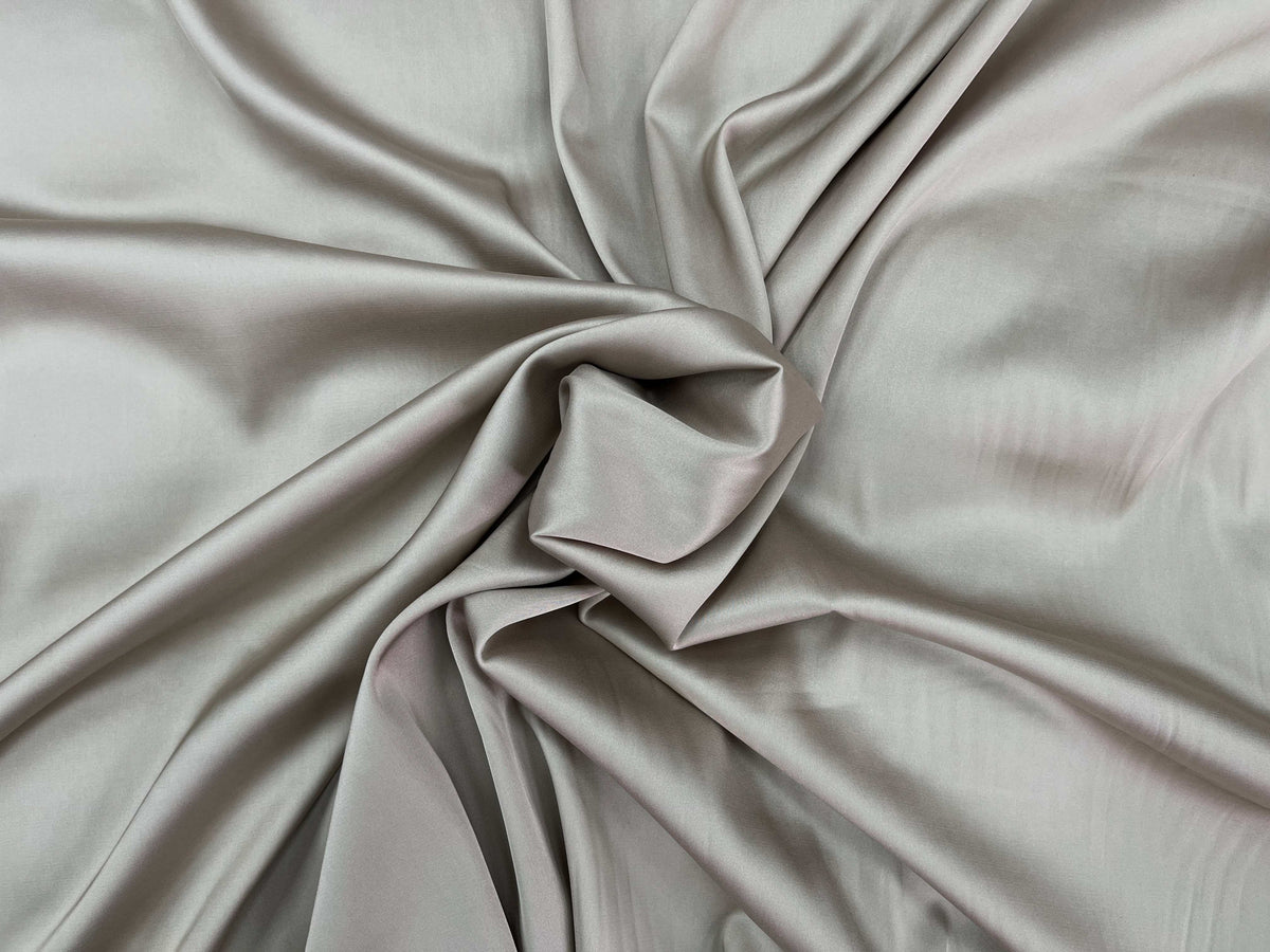 Smooth barley-colored Cheapfabrics plain satin fabric, showcasing its sleek, shiny satin texture and soft drape.