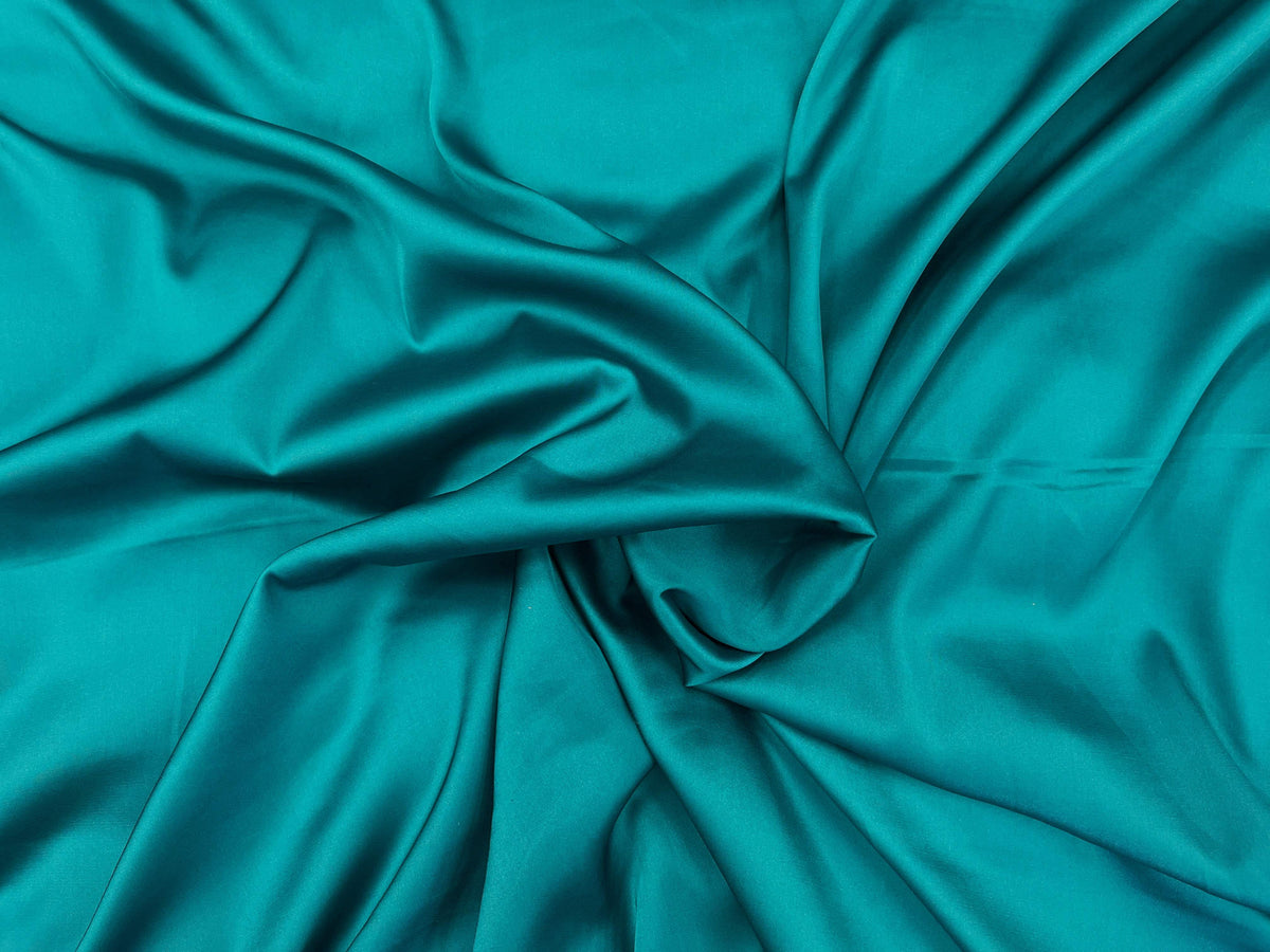 Dark jade plain satin fabric from Cheapfabrics, showcasing smooth, shiny satin material with a sleek, elegant finish.