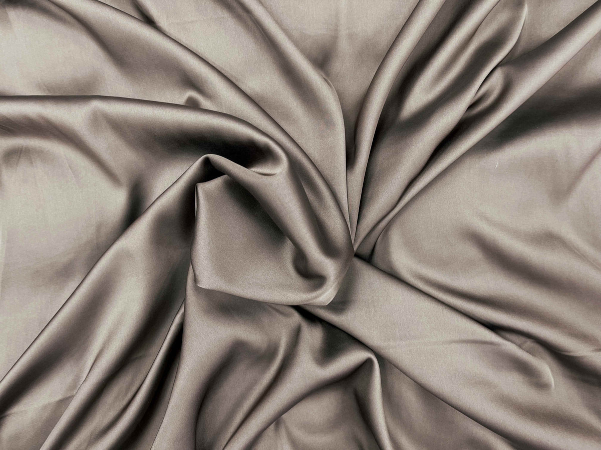 Smooth latte-colored satin fabric by Cheapfabrics, showcasing a sleek, shiny satin material with a soft, flowing texture.