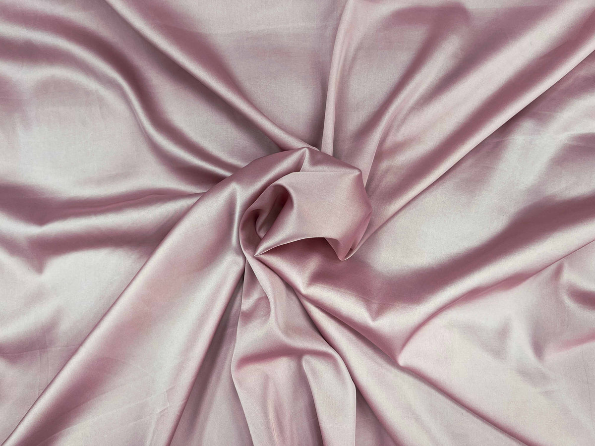 Pink sleek satin fabric from Cheapfabrics, showcasing smooth, shiny satin material ideal for elegant clothing and accessories.