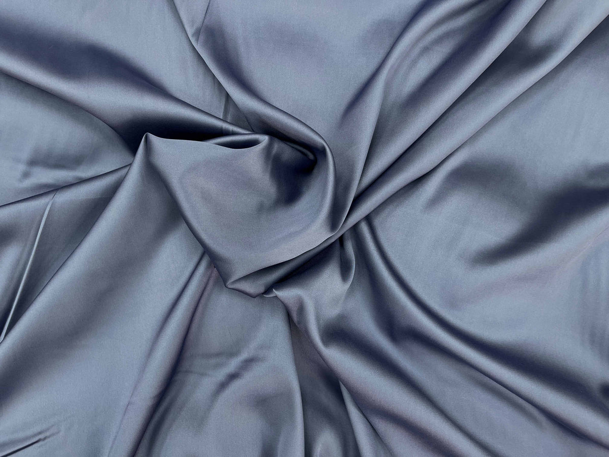 Violet sleek satin fabric by Cheapfabrics, smooth and shiny satin textile with a silky appearance.