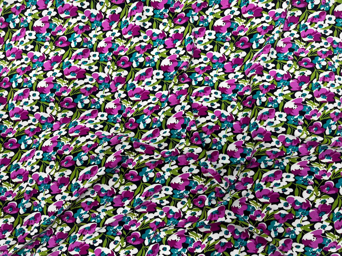 Small floral printed jersey fabric in cerise by Cheapfabrics, showing vibrant floral patterns on soft jersey material.