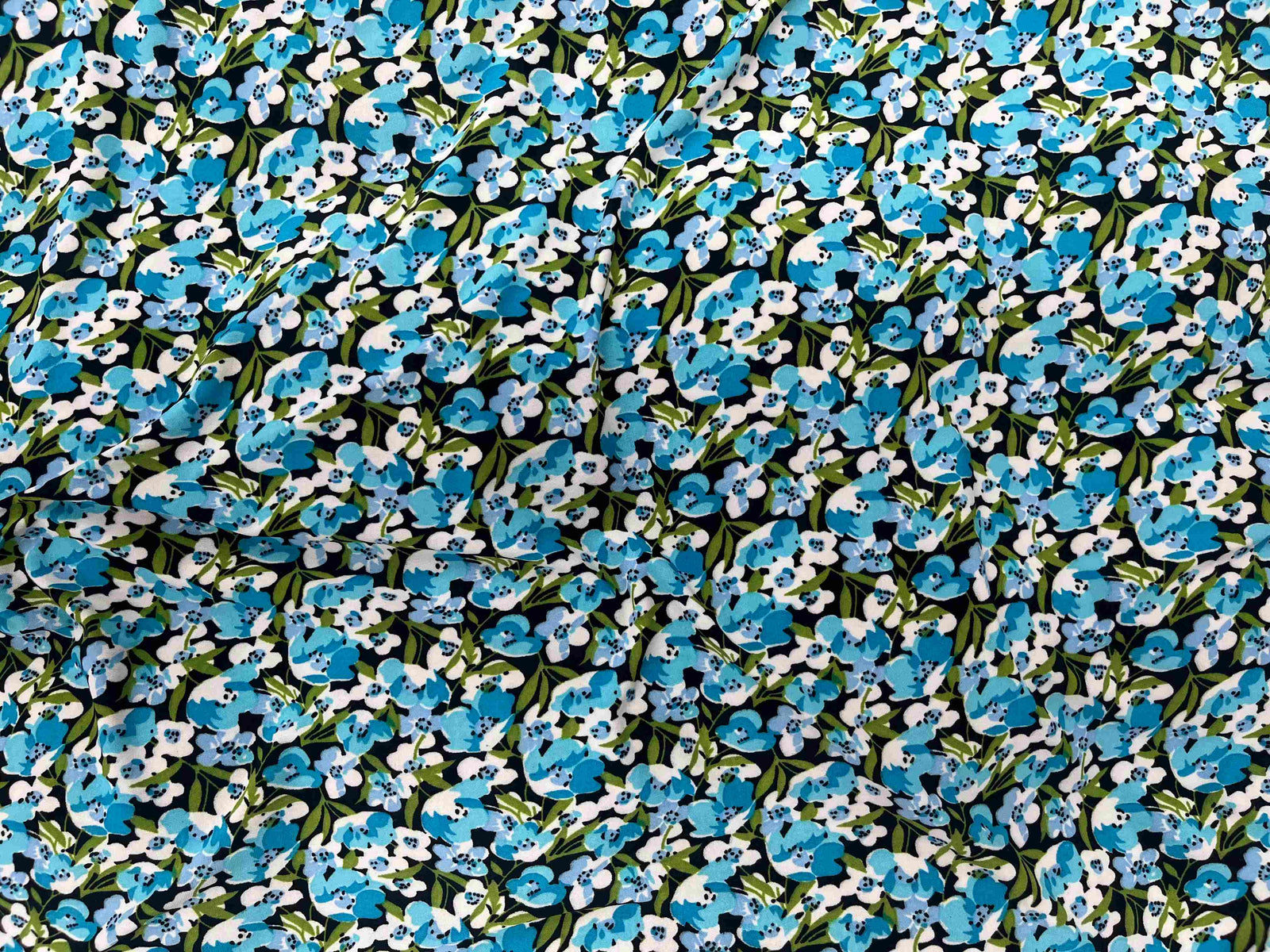 Small floral printed jersey fabric by Cheapfabrics, featuring a colorful floral design on soft jersey material.