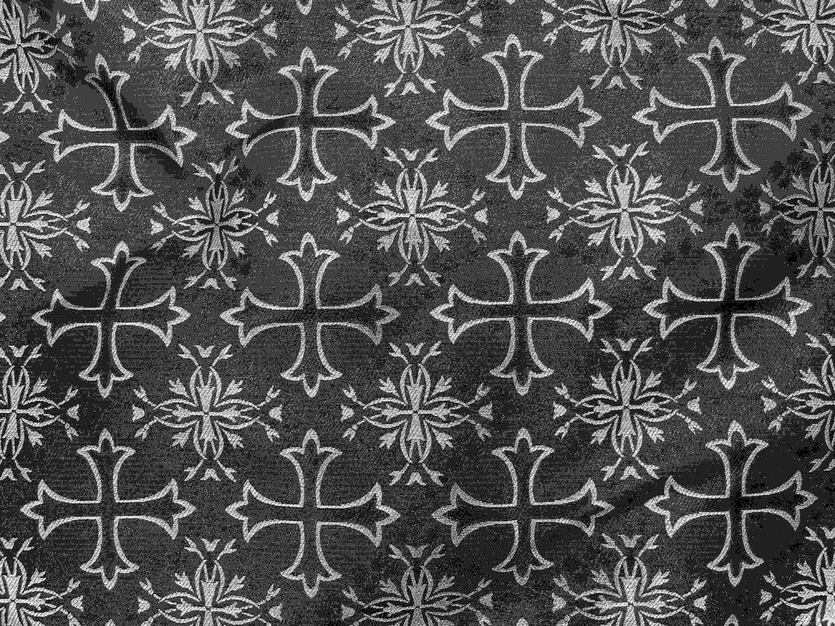 Black and silver spiritual brocade fabric with a cross design, showcasing intricate woven patterns and elegant craftsmanship.