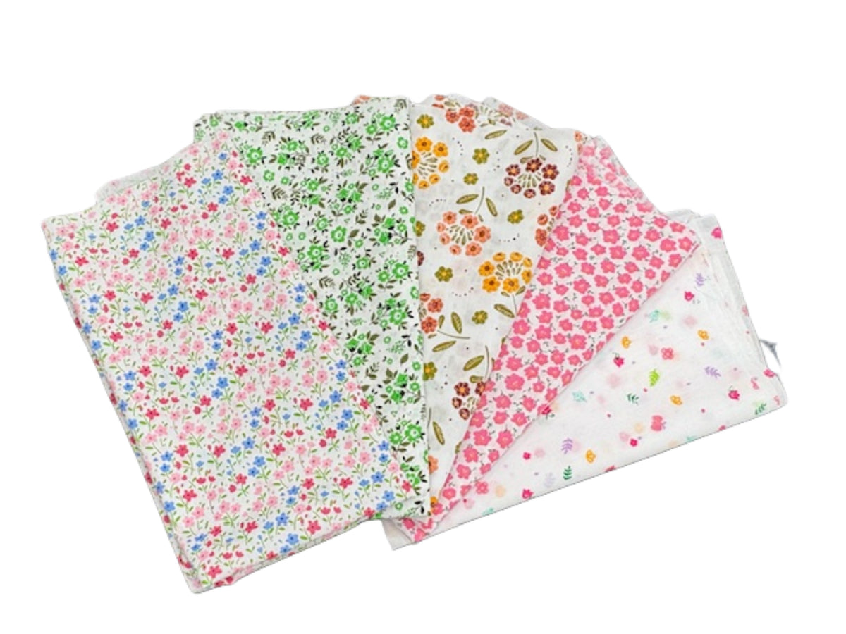 Five floral print fat quarters in a bundle, showcasing vibrant spring colors and patterns, from Cheap Fabrics.