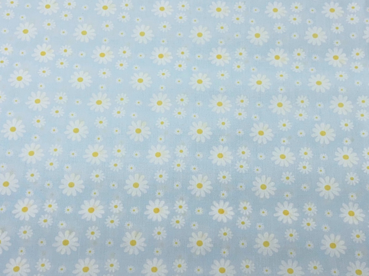 Blue Sunshine Daisies polycotton fabric by Cheap Fabrics featuring a cheerful daisy pattern on soft, lightweight fabric.