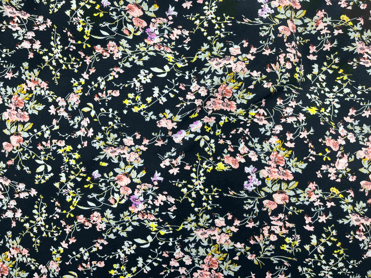 Textured stretch crepe fabric in Vintage Meadow black by Cheap Fabrics, showing a detailed close-up of the fabric's textured surface.