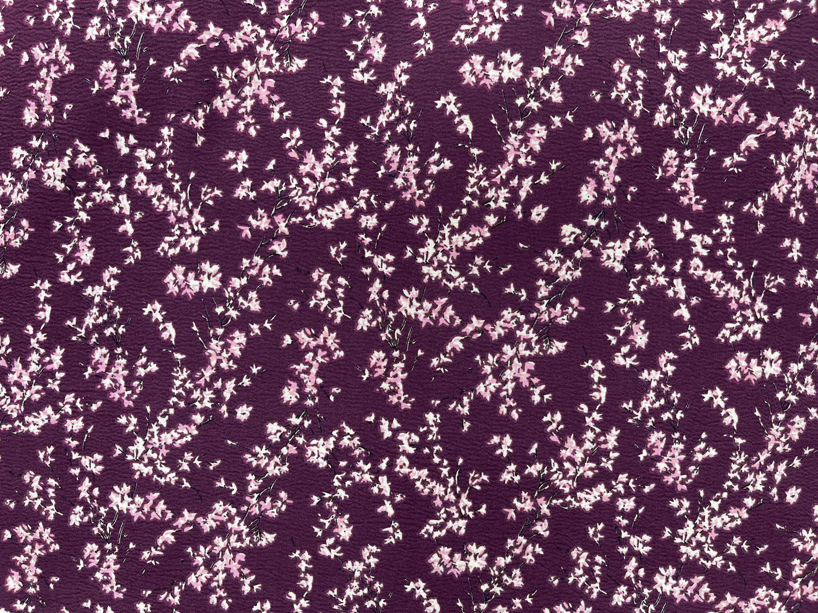 Gray textured stretch crepe fabric from Cheap Fabrics, showcasing its smooth, flexible surface perfect for fashion and sewing projects.