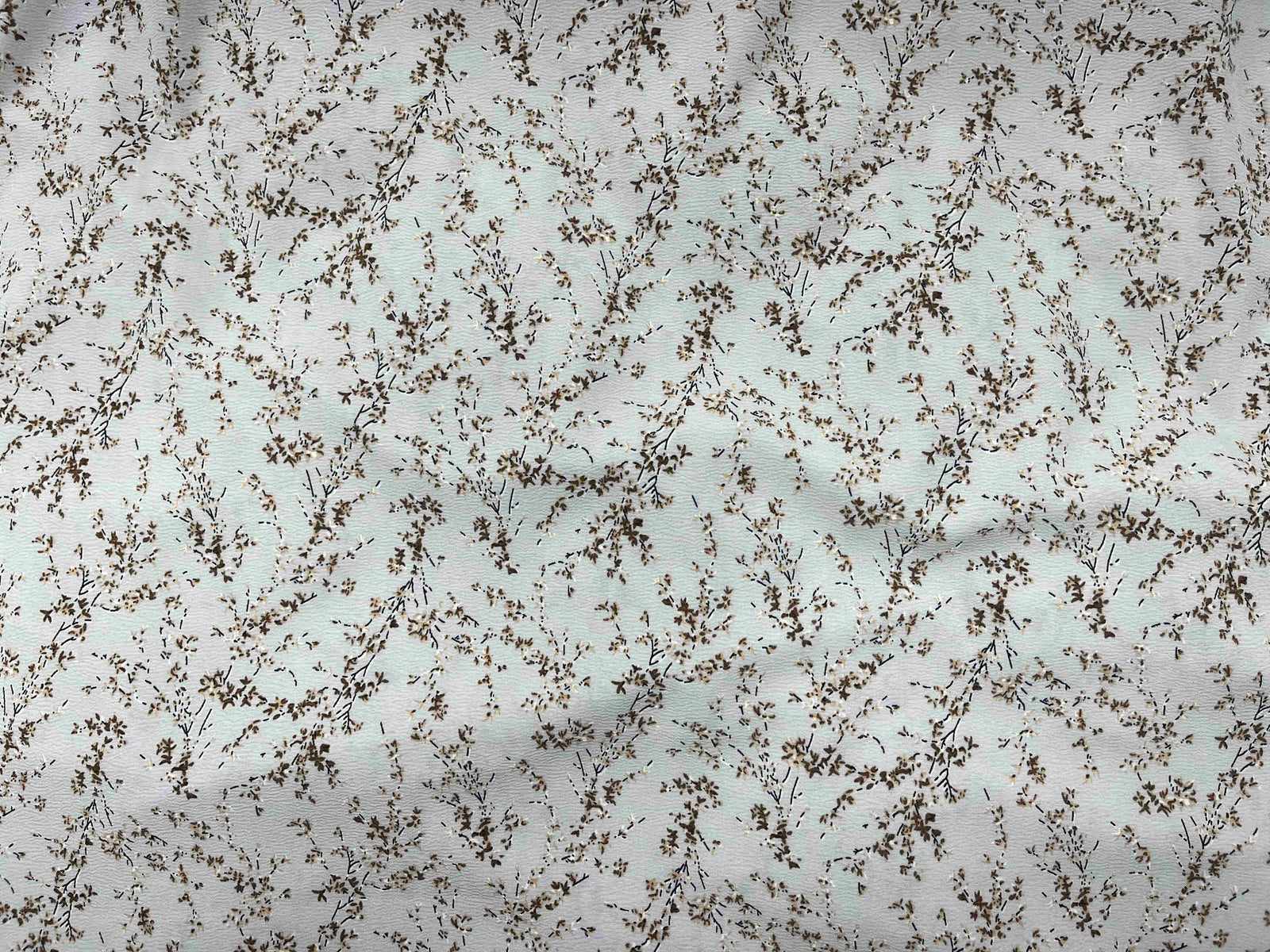 Gray textured stretch crepe fabric from Cheap Fabrics, showcasing its smooth, flexible surface perfect for fashion and sewing projects.