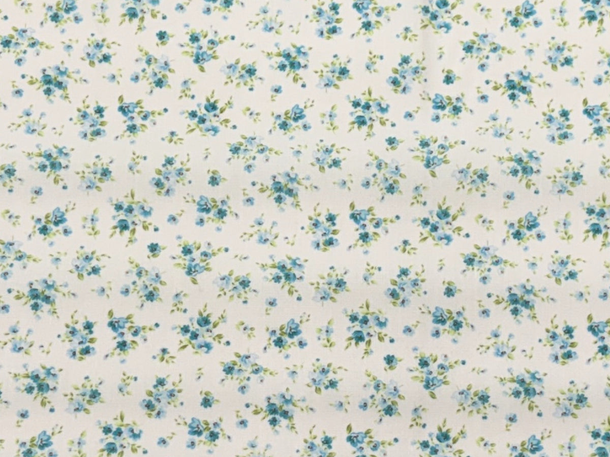 Aqua polycotton fabric with tiny floral clusters, showcasing a soft, lightweight textile by Cheap Fabrics.