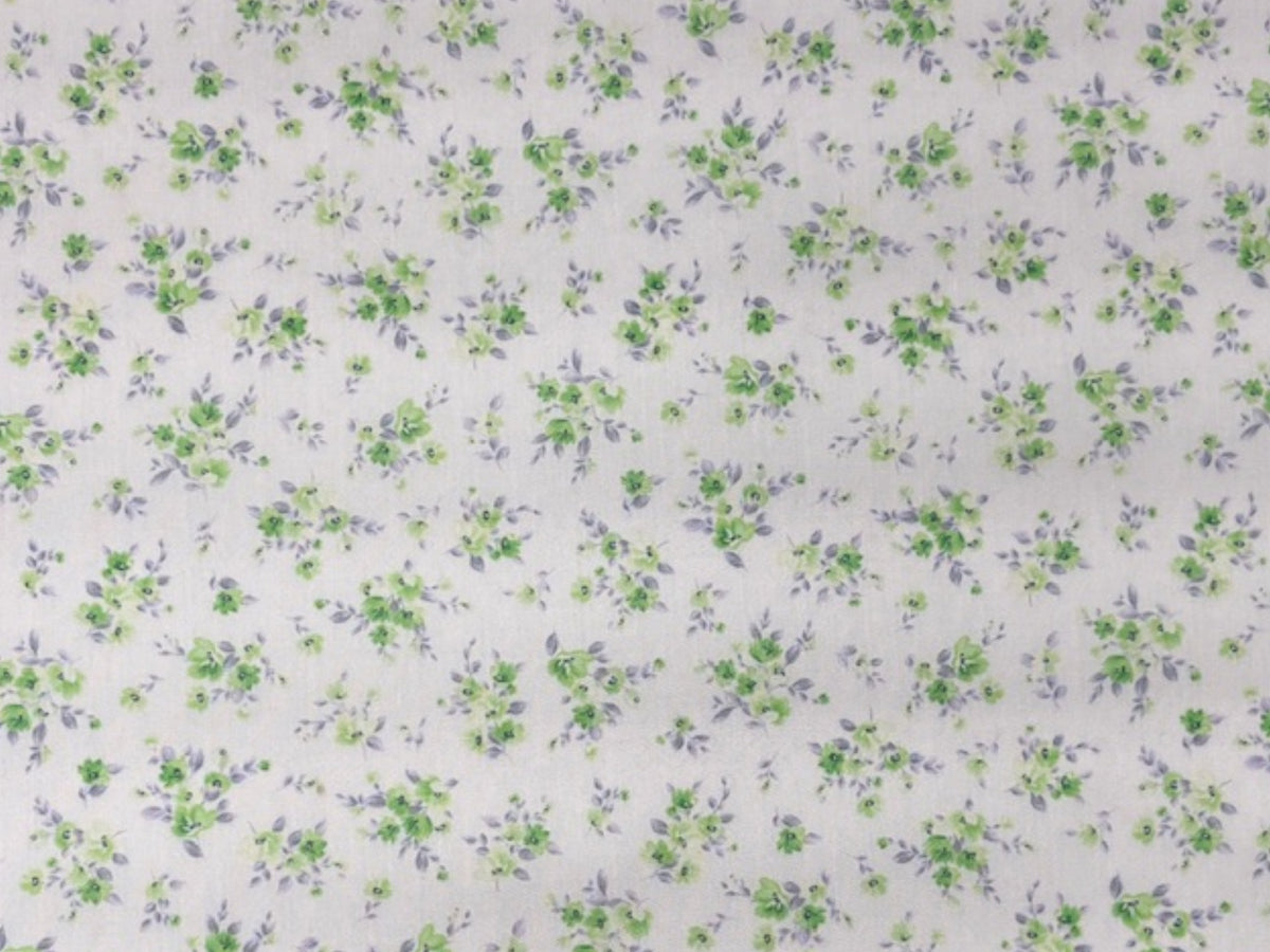 Green polycotton fabric with tiny floral cluster pattern, perfect for sewing and craft projects by Cheap Fabrics.