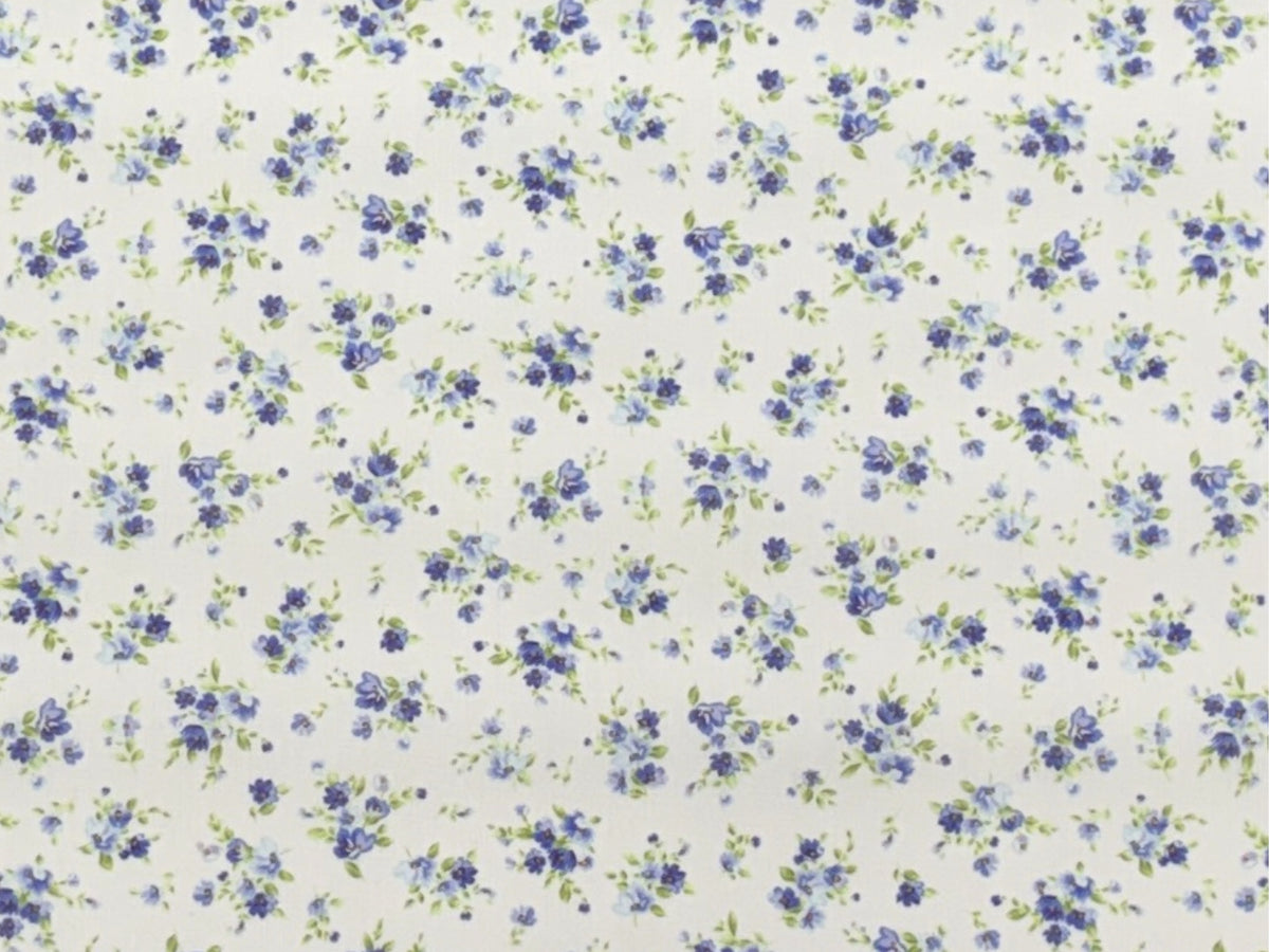 Close-up of Cheap Fabrics' purple polycotton fabric with tiny floral cluster pattern, showcasing soft poly/cotton texture and detailed print.