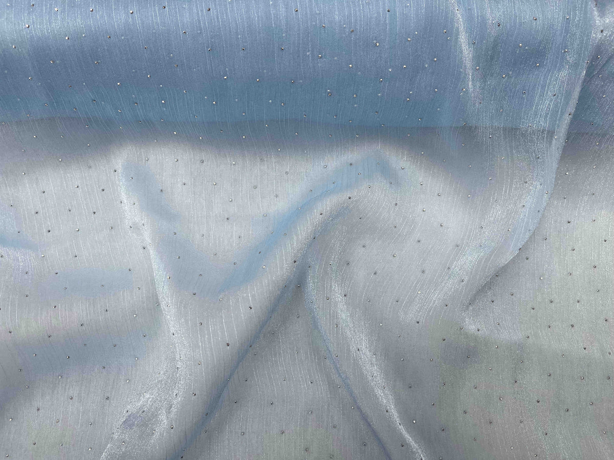 Pale blue Twinkle Stone Organza Fabric by Cheap Fabrics, showcasing the lightweight, shimmering sheer material with a subtle sparkle.