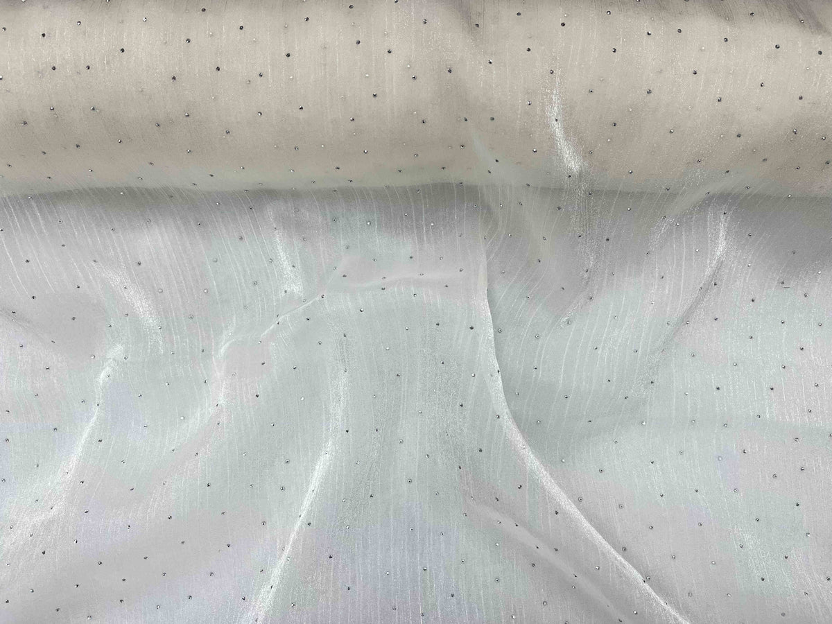 Ivory Twinkle Stone Organza Fabric by Cheap Fabrics, showcasing shimmering, lightweight sheer material with subtle sparkle details.