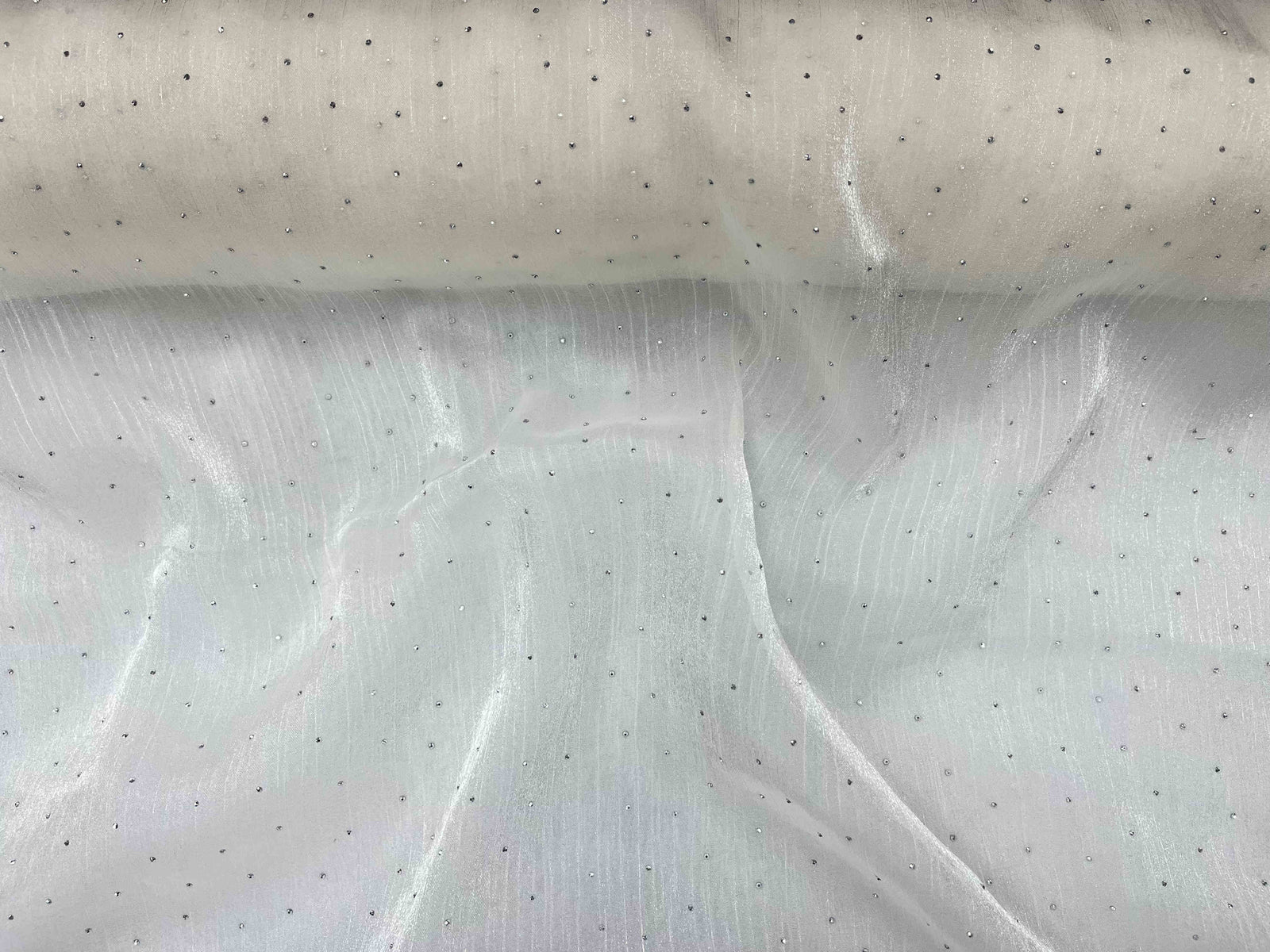 White Twinkle Stone Organza Fabric by Cheap Fabrics showcasing shimmering, lightweight, sheer material ideal for elegant garments and decor.