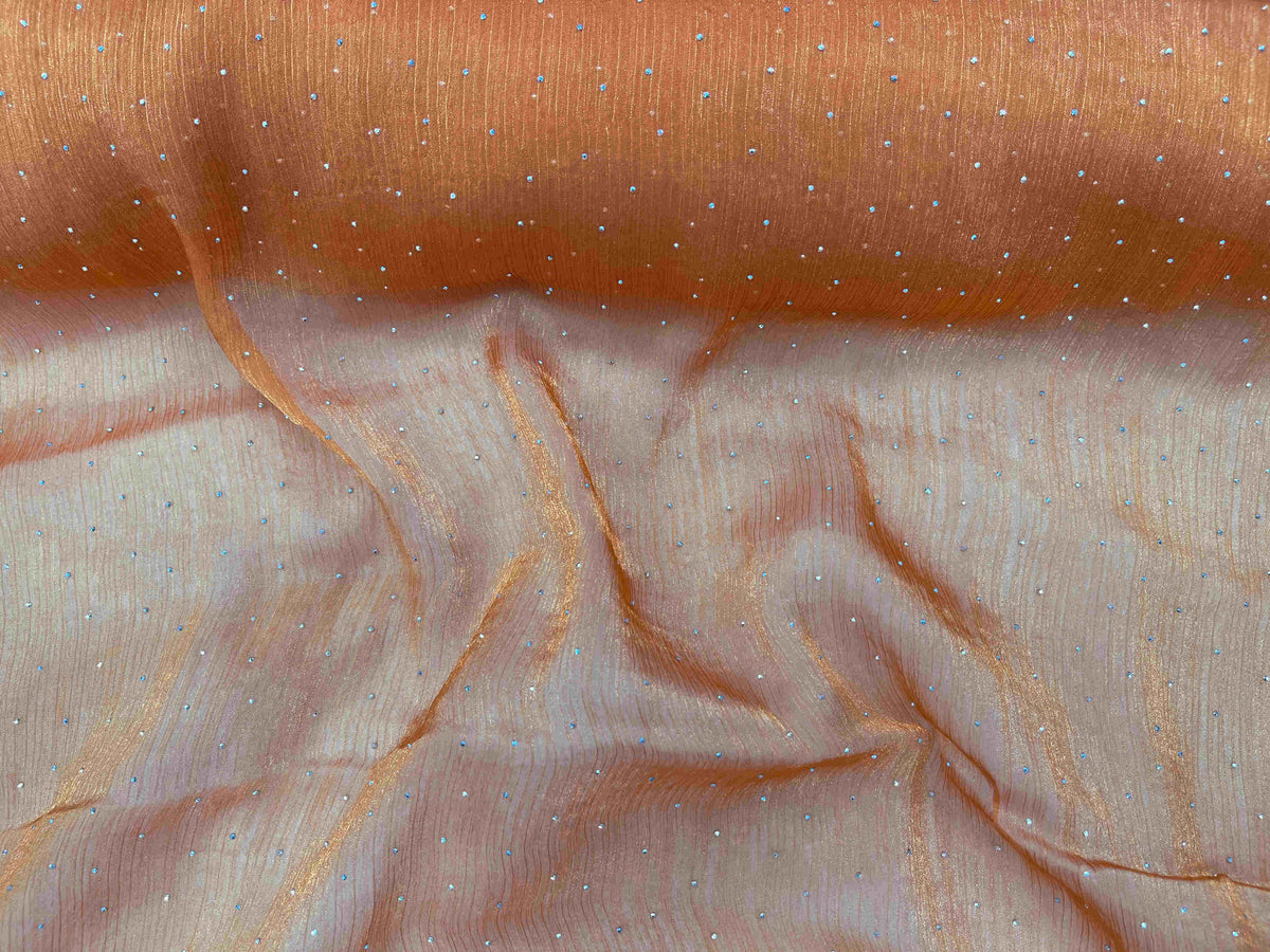 Orange Twinkle Stone Organza Fabric from Cheap Fabrics, showcasing a shimmering sheer textile with sparkly stone accents.