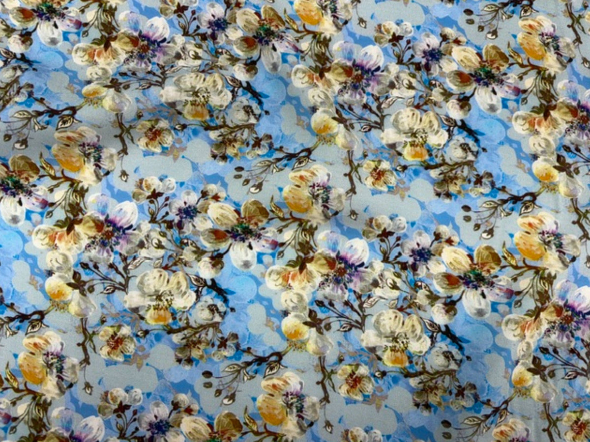 Blue Deluxe Printed Viscose Fabric with budding floral pattern from Cheap Fabrics, showcasing soft, lightweight textile design.