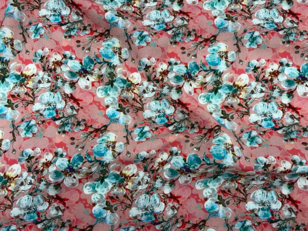 Deluxe printed viscose fabric with budding floral pattern in coral, showcasing soft, lightweight textile from Cheap Fabrics.