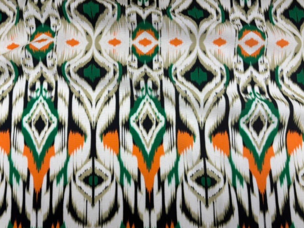 Green tribal printed viscose fabric from Cheap Fabrics featuring vibrant, detailed tribal patterns on soft, lightweight textile.