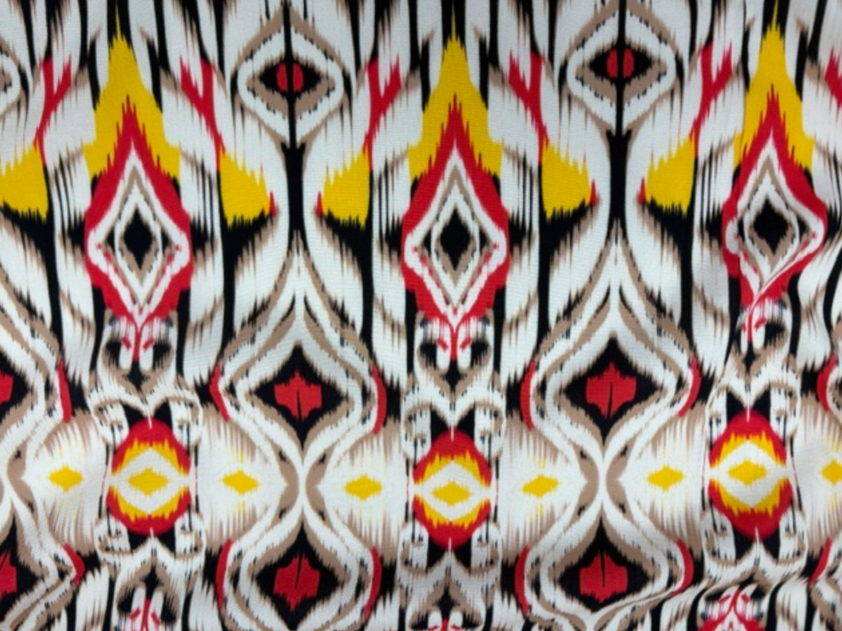 Red tribal printed viscose fabric from Cheap Fabrics featuring vibrant, intricate tribal patterns on smooth, lightweight material.