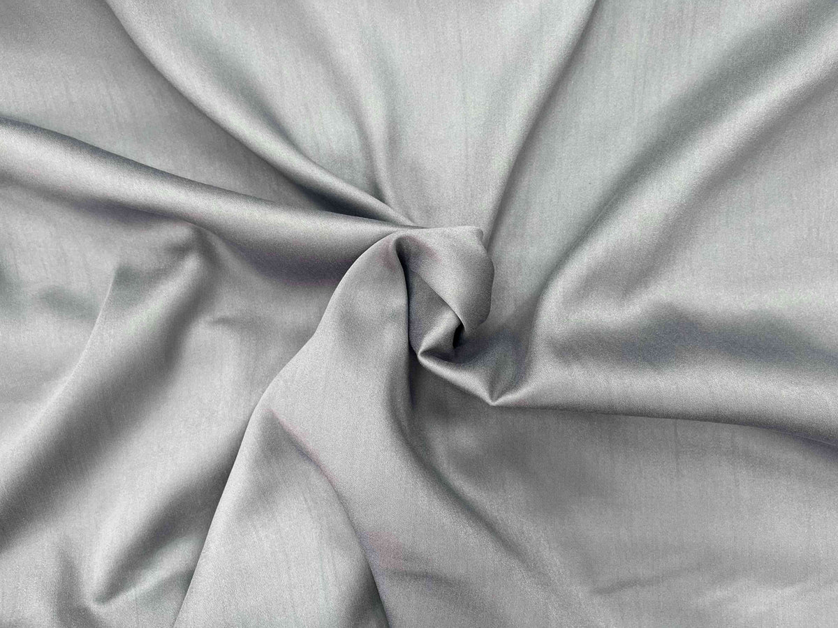 Gray plain viscose satin fabric from Cheapfabrics, showcasing smooth, shiny viscose material ideal for clothing or crafts.